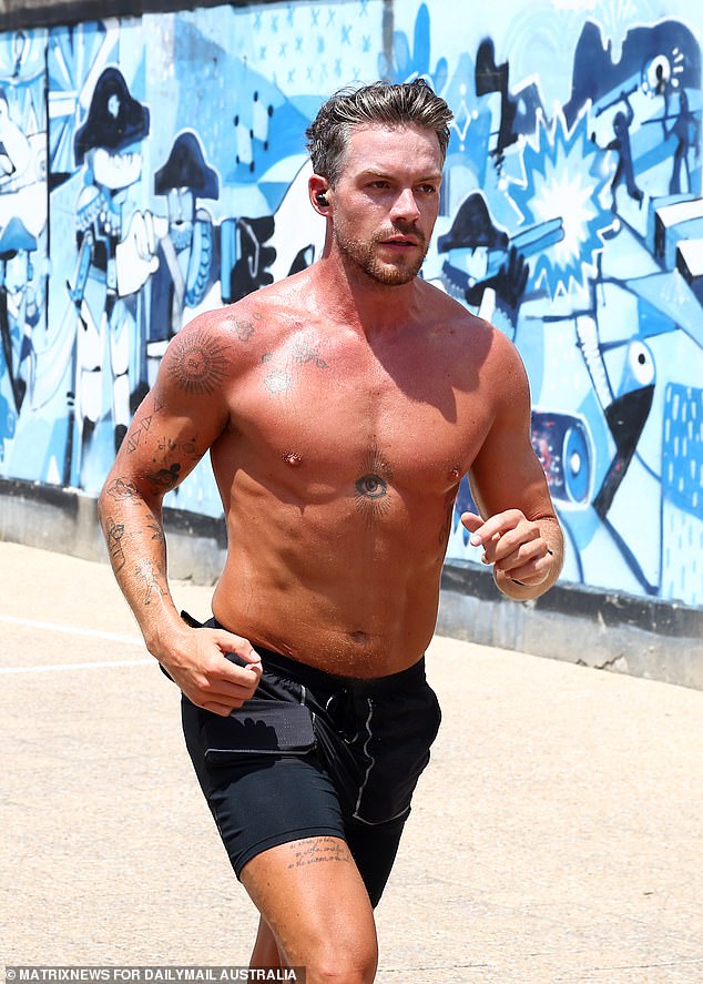 The tanned god competed with his workout style in a pair of skintight shorts and ear pads.