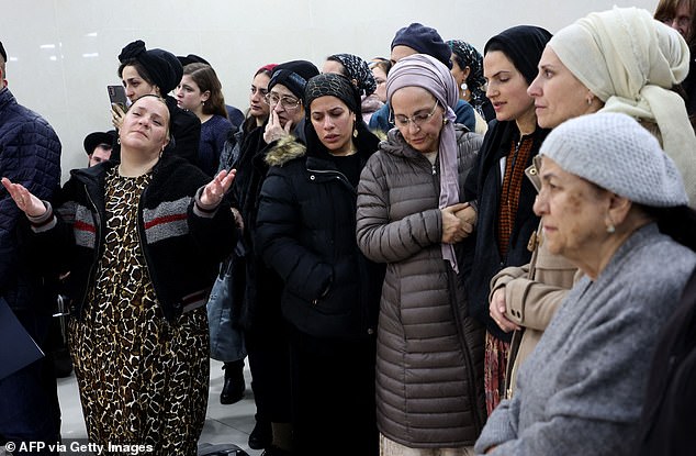 Family and friends mourn at the funeral of 14-year-old Asher Natan