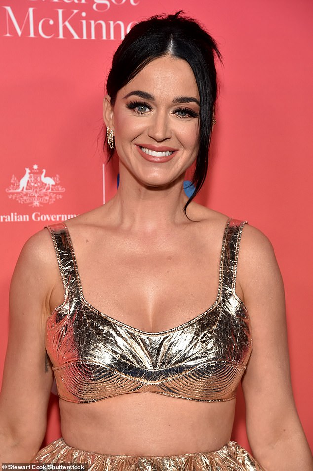 Glam: The California Gurls singer swept her black tresses back with face-framing bangs and accessorized with coordinating silver bracelets and dangling earrings.