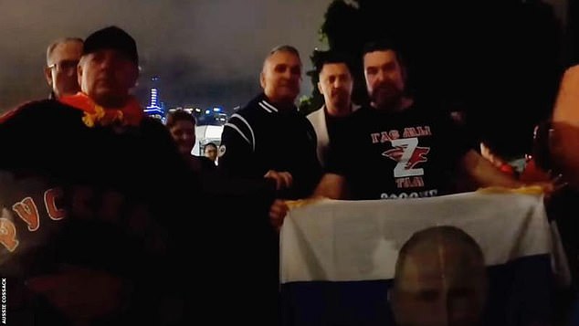 Djokovic (second left) was seen with a fan who was holding a Russian flag with Putin's face on it and wearing a T-shirt with the Z symbol of the Russian armed forces.