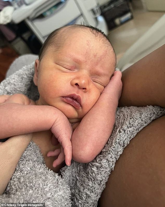 New baby: Chrissy gave birth to daughter Esti two weeks ago on January 13.  She shares two older children with her husband John Legend, Luna, 6, and Miles, 4.