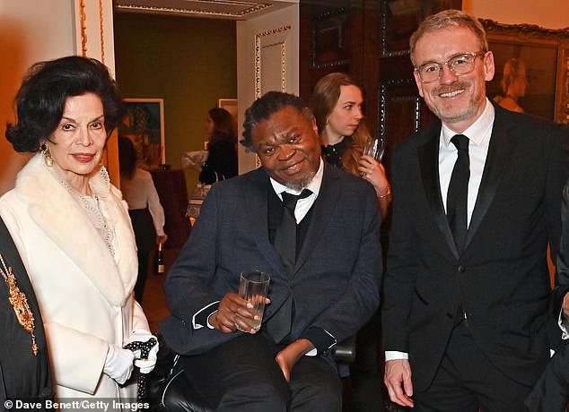 Smiles: Bianca, Yinka and Axel all smile as they enjoy the charity event on Saturday night in London.