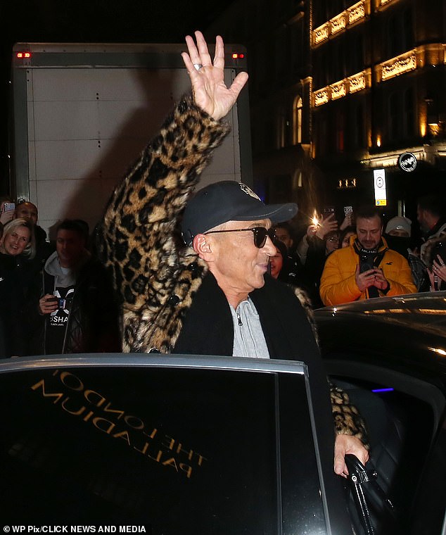 Stylish: Bruno cut a casual figure in a gray tracksuit and teamed with a leopard-print coat