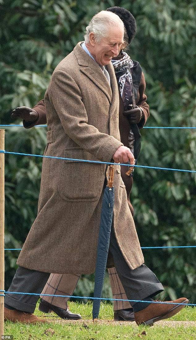 Good cheer: At one point, King Charles appeared to be grinning broadly as he walked alongside his sister in Sandringham today.