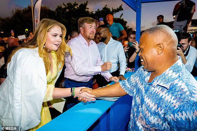 Cheers: The young royal was photographed meeting the locals during the engagement at the special edition Taste of Bonaire last night