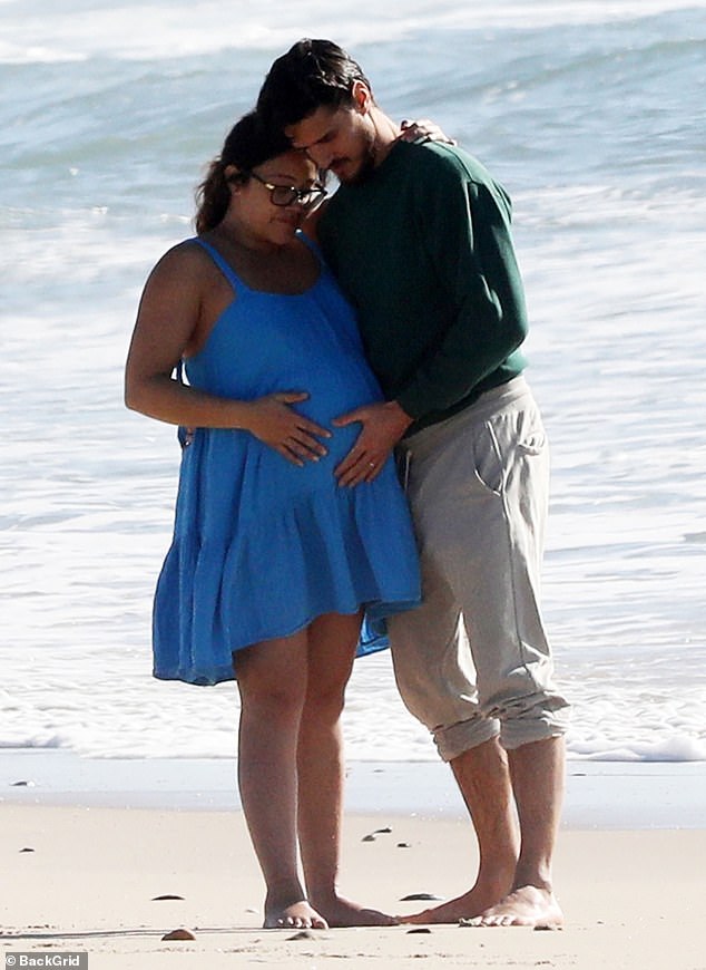 A tender moment: The Golden Globe-winning actress and her husband of almost four years stroked her tummy in a sweet moment