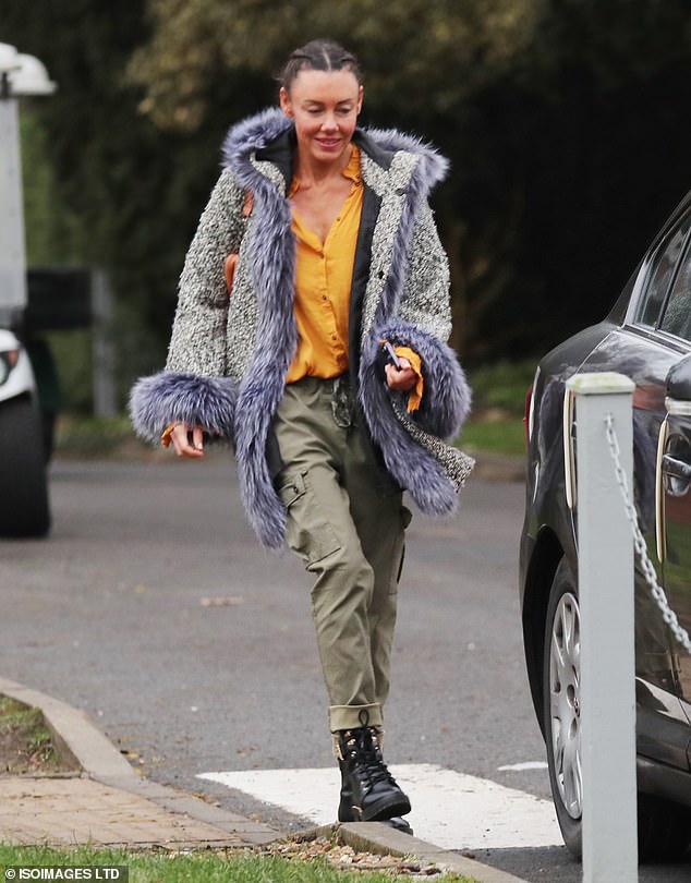 Style: Michelle bundled up in a blue and gray fur-trimmed jacket, which she paired with a mustard shirt, khaki pants, and black boots.