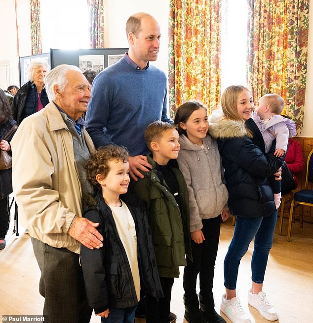 Prince William, 40, looked dapper in a blue sweater teamed with a matching plaid shirt as he chatted with members of the community who gathered at Snettisham Memorial Hall to remember the victims of the 1953 floods.