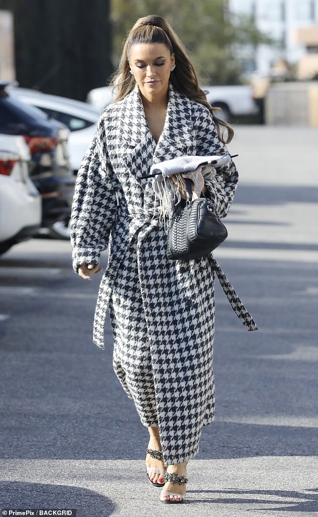 Glamorous: The star of Netflix's hit reality series Selling Sunset stepped out in the patterned coat and had her hair tied up in a sleek ponytail while running errands in West Hollywood