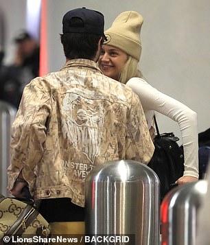 Match Type: Her new boyfriend rocked a brown camouflage jacket and a navy trucker hat.