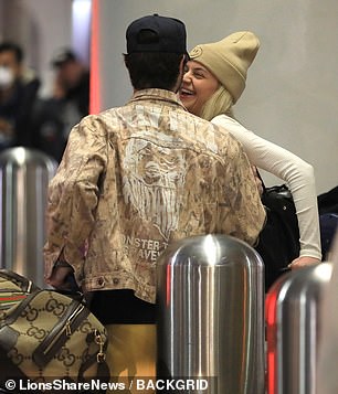 Having fun: While waiting for their luggage, the couple seemed to share a lot of laughs