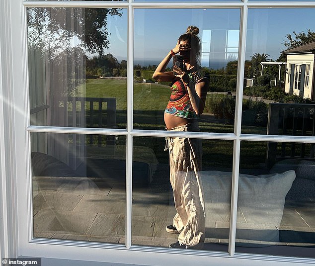 Baby announcement!  In a carousel of snaps that she had captioned, 'Recent,' the former Victoria's Secret Angel shared a selfie she took in a window reflection to show a glimpse of her baby bump.