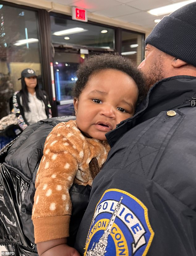 Kason Thomas, just five months old, was found on December 22.  He is being held in the arms of an Indianapolis police officer.