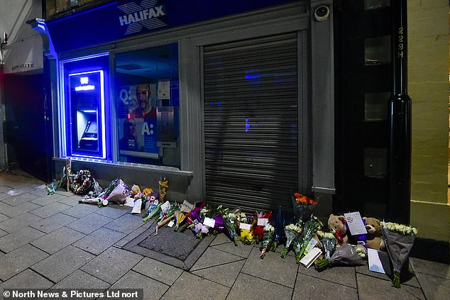 One tribute read: 'To our baby Holly.  Our hearts hurt a lot right now.  we love you so much.'  Pictured: Tributes left at the scene last night