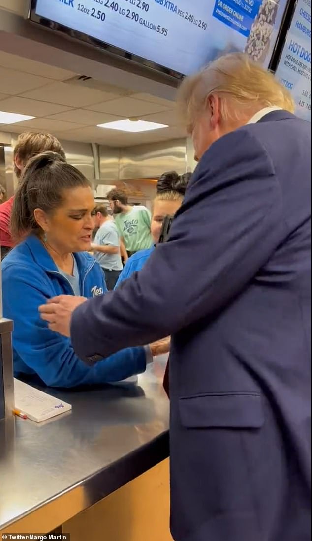 A Zesto employee clasps the former president's hand in prayer as he makes a campaign technical stop in South Carolina.