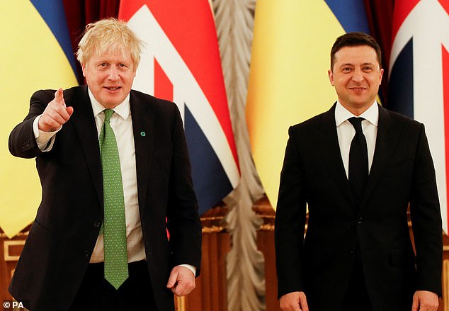 The staggering threat was made in February last year, after Johnson visited Kyiv to assure Ukraine's President Volodymyr Zelensky (right) that Britain would back his country if Russia invaded.