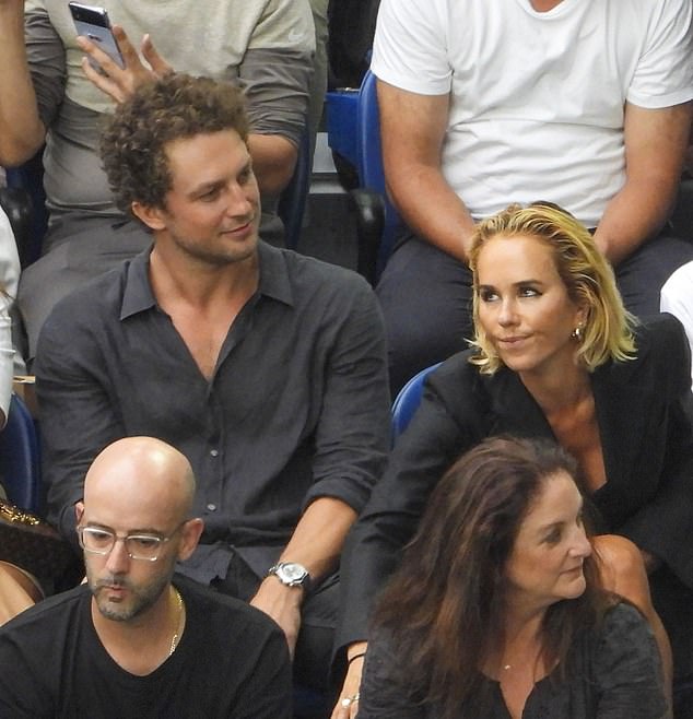 Ben also looked dapper in a black button-down shirt and pants as he sat next to his friend at the match.