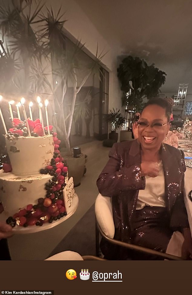 Birthday girl: Kim also took to her Stories to share a snapshot of Oprah receiving a birthday cake at the party, which took place the night before her actual birthday.