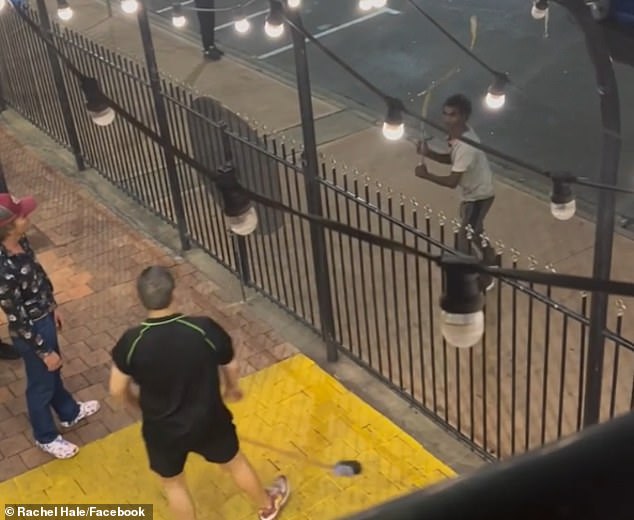 A third violent video showed a young Aboriginal man approaching the pub wielding a large tree branch with which he was attempting to attack drinkers over the fence, prompting one to use a broom to try to block it.