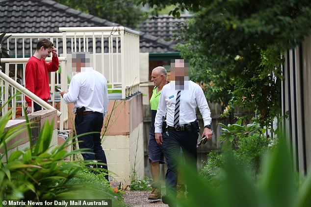 Detectives are seen at the Wyong unit complex on Monday.