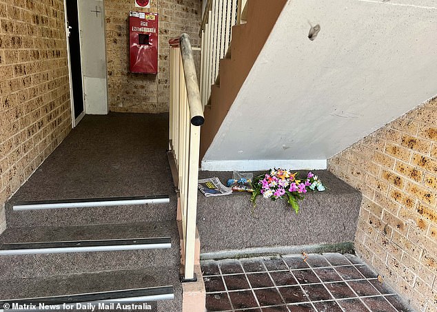 Flowers and a newspaper detailing the incident have been left outside the unit.