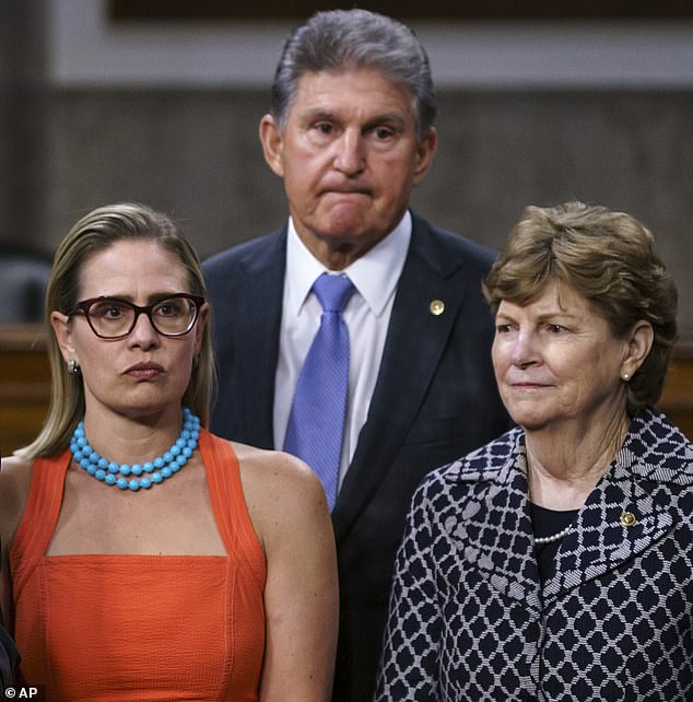 Senators Kyrsten Sinema, Joe Macnhin and Jeanne Shaheen during a press conference on the infrastructure package negotiations