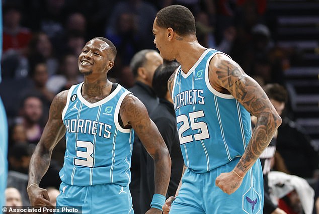 Hornets' Terry Rozier (L) reacts after making a 3-pointer as forward PJ Washington looks on