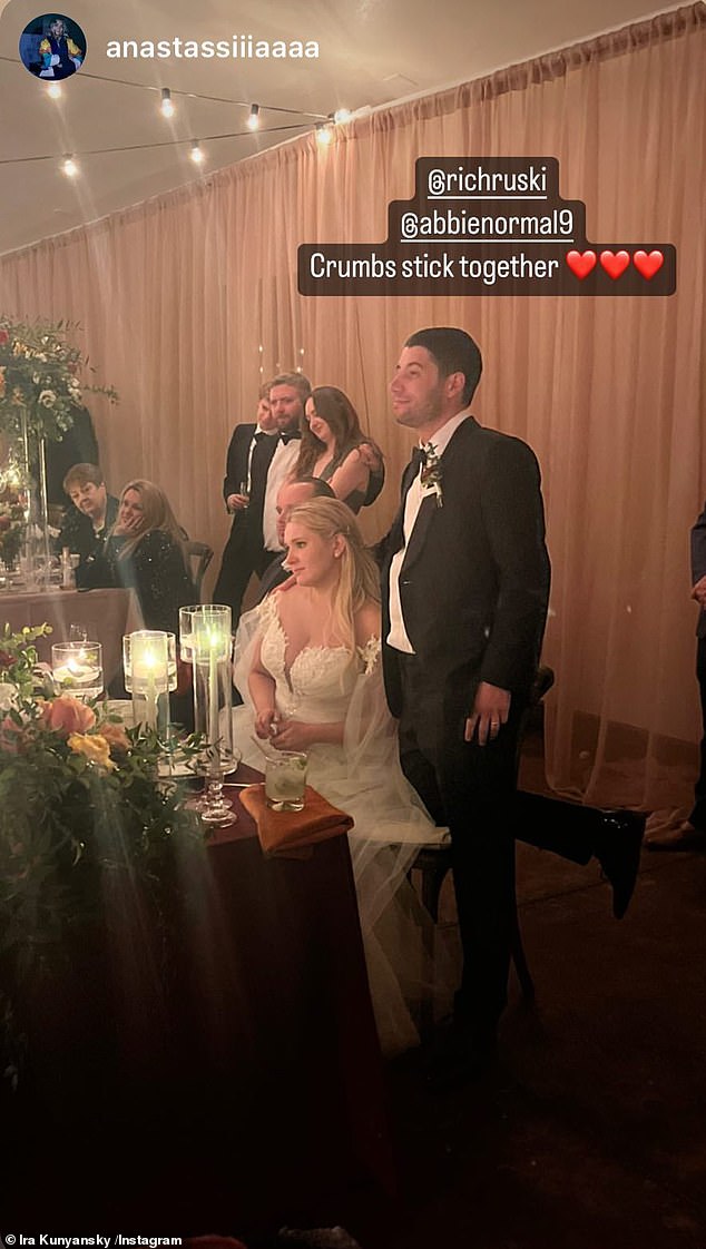 Sweet: Another photo saw Abigail sitting at her table during the wedding reception while her husband stood by her side