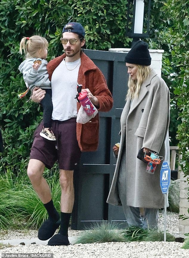 Fancy footwear: The Lizzie McGuire star, who was accompanied by daughters Banks and Mae, aged four and one, added some color to her look with a pair of red Adidas sneakers