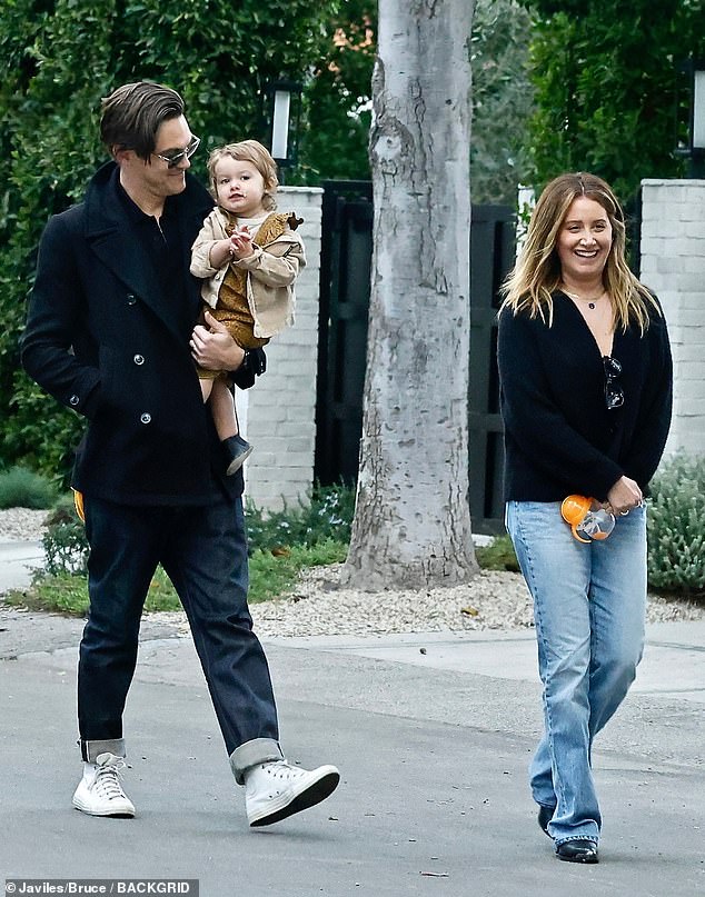 Taking it easy: Tisdale opted for a black cardigan and a matching pair of leather pumps.