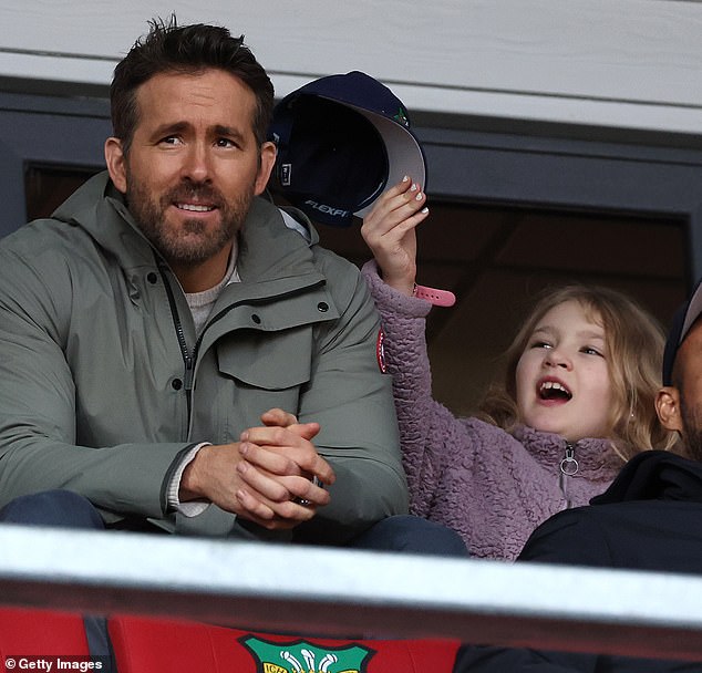 Cheeky: While it was an intense match, James at one point seemed more interested in what was going on in their seats, finding a cap which he cheekily tossed on his father's head.
