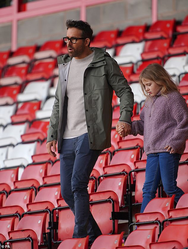Making moves: Before the game started, Ryan took his eldest son on a tour of the stands, and the doting father of three walked her onto the field