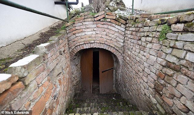 Austrian officials were tipped off about his erratic behaviour by worried neighbours and on Thursday attempted to question him but it is alleged that he reacted violently and attacked them. Pictured: An entrance to one of the cellars