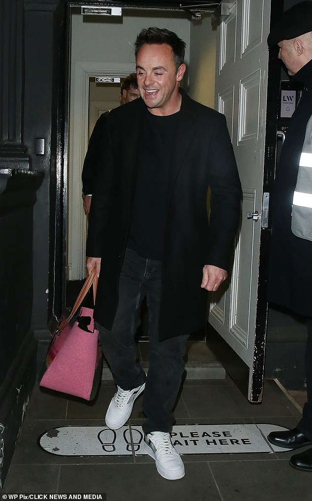 Doting: The TV star was always the doting husband as he carried his wife's bright pink handbag as they left the theater