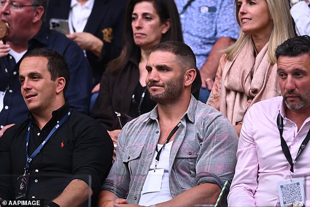 Retired NRL star Robbie Farrah (centre of photo) watches the men's Australian Open final on Sunday