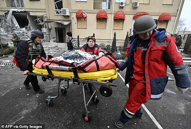 - Ukrainian medics carry the body of a local resident killed in a residential building after a Russian shelling in Kherson on Sunday.