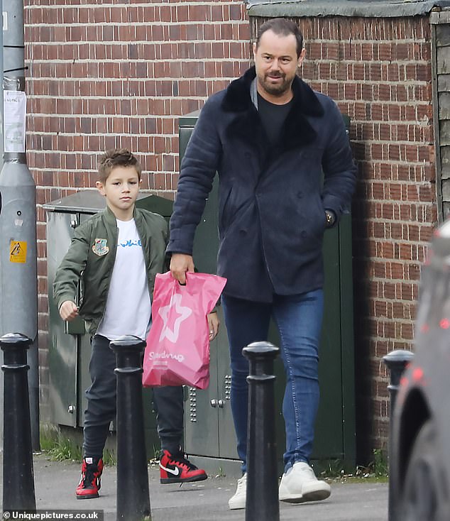 Family shopping trip: The Love Island star, 26, was joined by her father Danny, 45, and brother Artie, nine, for the photo as they went shopping