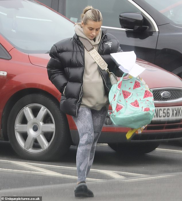 Casual: She swept her long blonde hair back into a ponytail for the outing and was seen carrying a shopping list and reusable bags