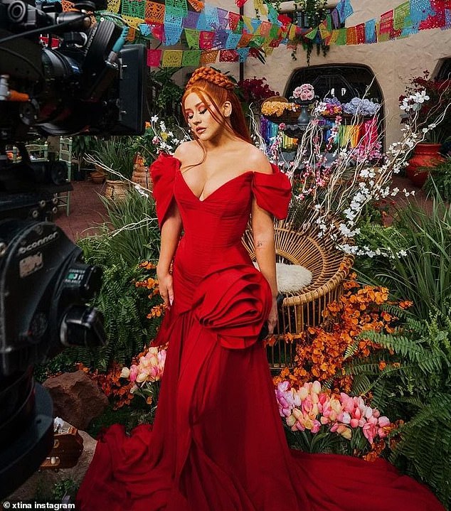 Gorgeous: The stunner also shared a behind-the-scenes look at some of the music videos for the song La Reina, where she donned a gorgeous red dress