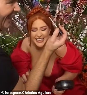 Naive: In candid behind-the-scenes snaps, Xtina could be seen in high spirits while putting on her makeup