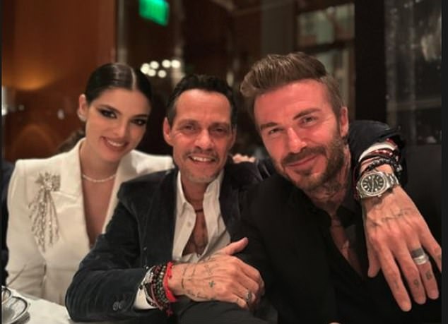 Big day: Victoria is in Miami with her family to celebrate the nuptials of singer Marc Anthony, 54, and Nadia Ferreira, 23, - with her own fashion label even designing the bridesmaids' dresses (David Beckham in the photo with the couple)