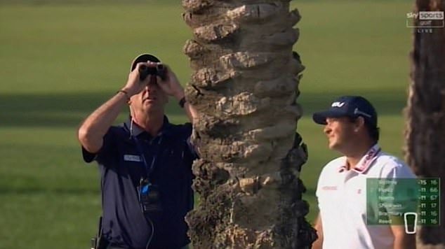 Reed (right) pictured with a tournament official who also looked at the tree through binoculars