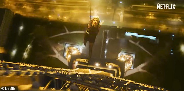 Yes, that's Aniston: Jennifer is seen wearing a black dress while holding on to a wire outside the Eiffel Tower.