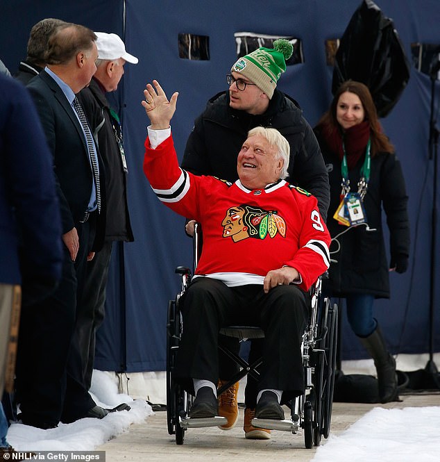 Former Chicago Blackhawks player Bobby Hull waves to fans as he is pushed in a wheelchair along the stadium wall before the Bridgestone NHL Winter Classic 2019 between the Boston Bruins and Chicago Blackhawks at Notre Dame Stadium on January 1, 2019 in South Bend.