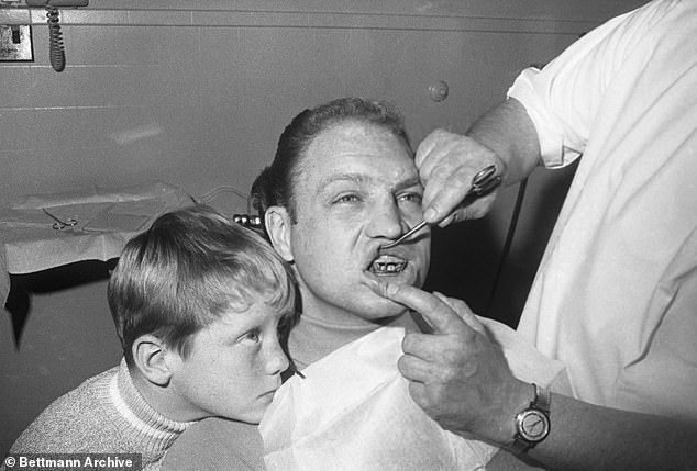 Hull gets sympathy from his son, Bobby Jr., as he gets his jaw wired here on December 27.  An old fracture was aggravated in one match when Hull was elbowed in the face.  While he recovers, Hull will miss the next games