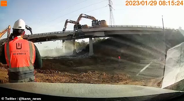 The bridge collapsed while four yellow Caterpillar machines were drilling into the centre foundations to break away the middle section during a demolition in Israel