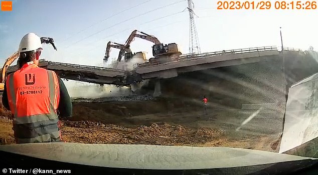 One CAT machine working on the right side of the bridge was thrown into the centre and on its side and was hidden in a cloud of dust