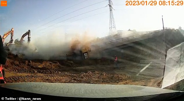 One CAT machine working on the right side of the bridge plunged forward before it toppled over the side