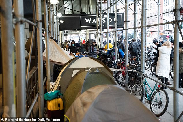 The open-air encampment sprang up shortly after the immigrants were evicted from the hotel, prompting NYPD officers to arrive at the scene just hours later.