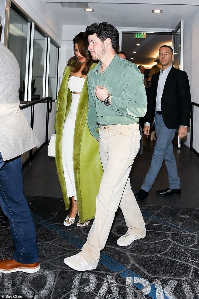 Big night: Joe's younger brother, Nick Jonas, cut a dashing figure in a light gray shirt, beige pants and a matching pair of sneakers with white accents